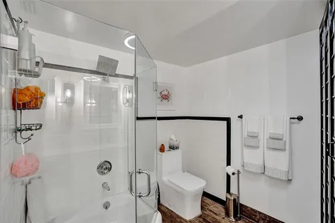 a bathroom with a shower toilet and sink