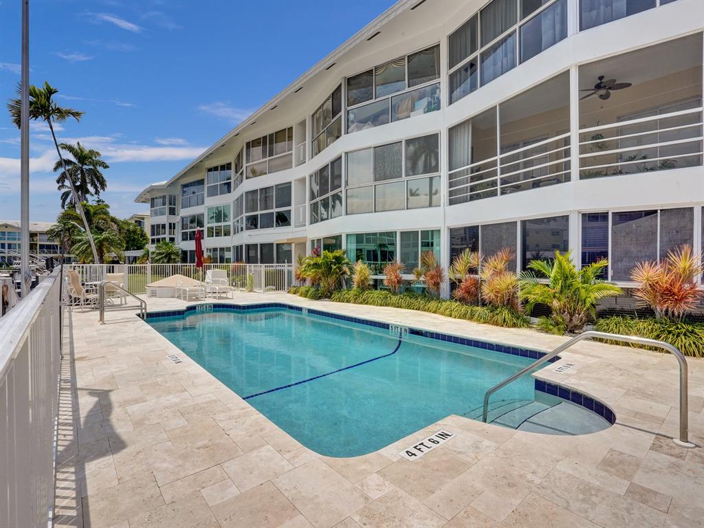 3090 Northeast 48th Street, Unit 316 Fort Lauderdale, FL 33308 - Photo 38 of 49 a view of building with outdoor space and swimming pool