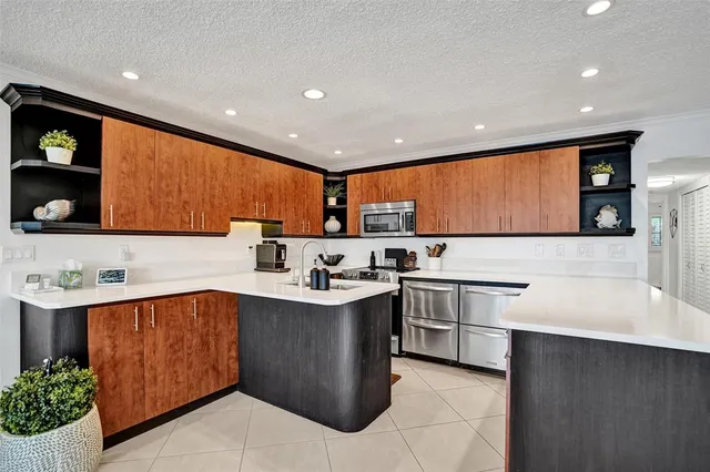 a kitchen with stainless steel appliances a sink stove and cabinets