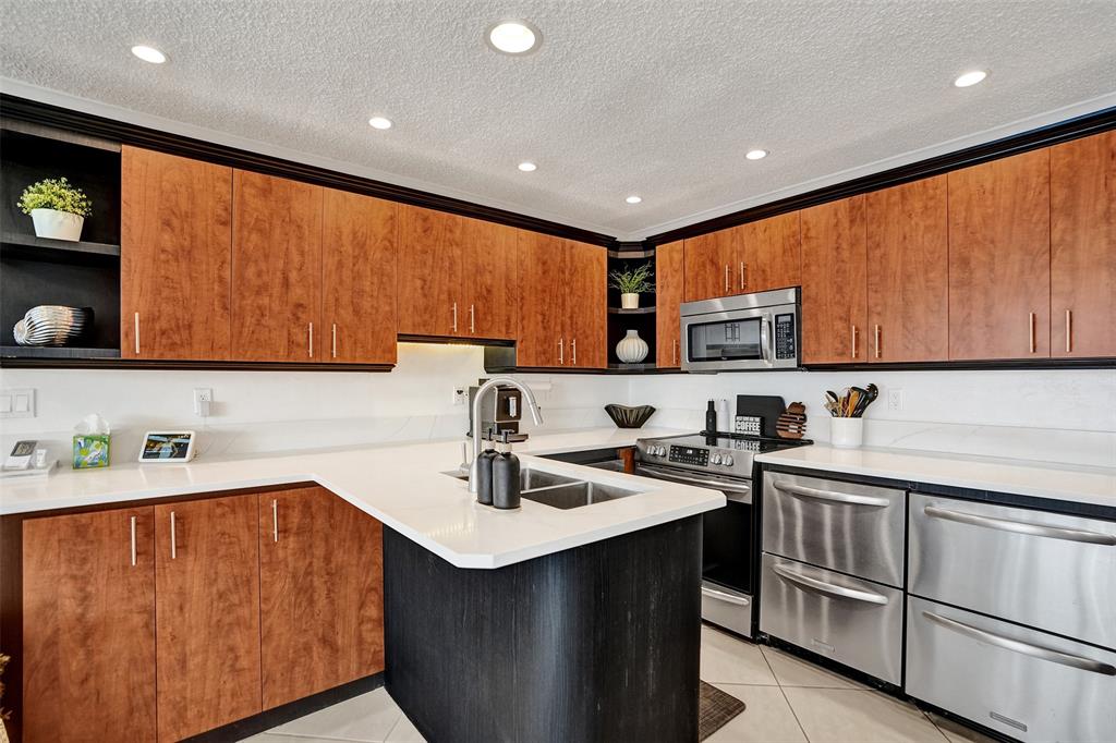 3090 Northeast 48th Street, Unit 316 Fort Lauderdale, FL 33308 - Photo 10 of 49 a kitchen with a sink cabinets and window