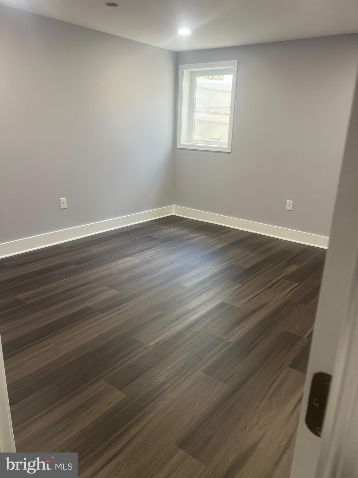2600 Kingsway Road Fort Washington, MD 20744 - Photo 13 of 37 a view of an empty room with wooden floor and a window