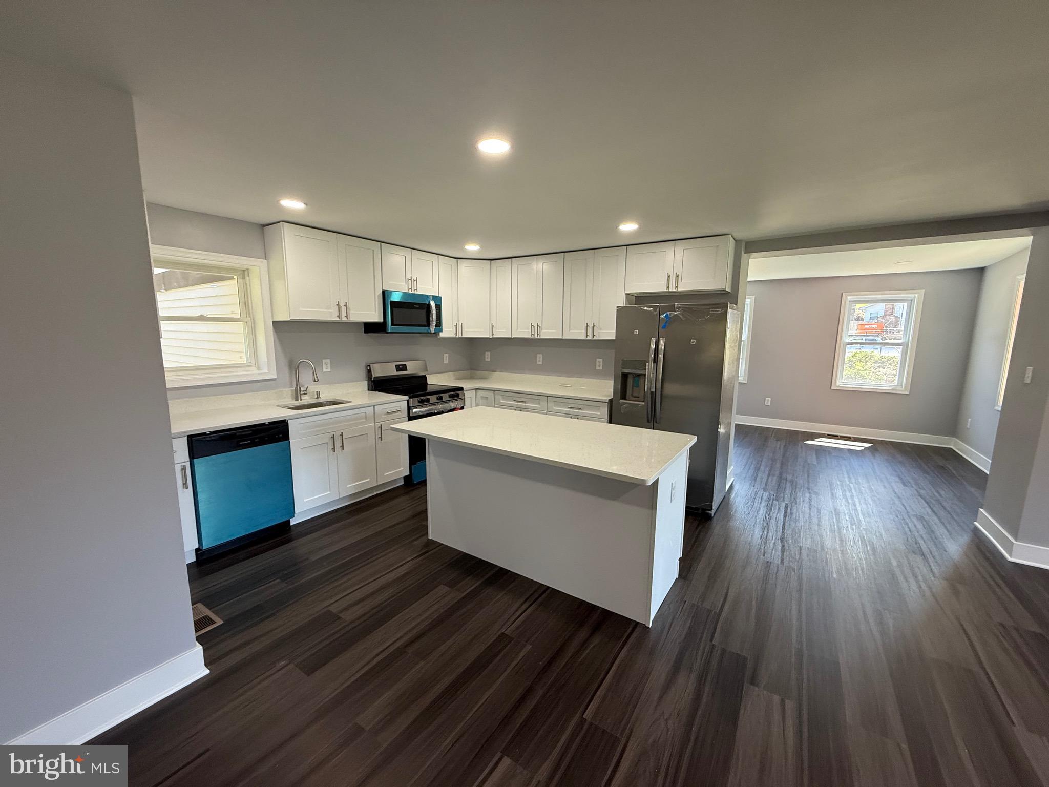 2600 Kingsway Road Fort Washington, MD 20744 - Photo 7 of 37 a kitchen with wooden floors and white stainless steel appliances