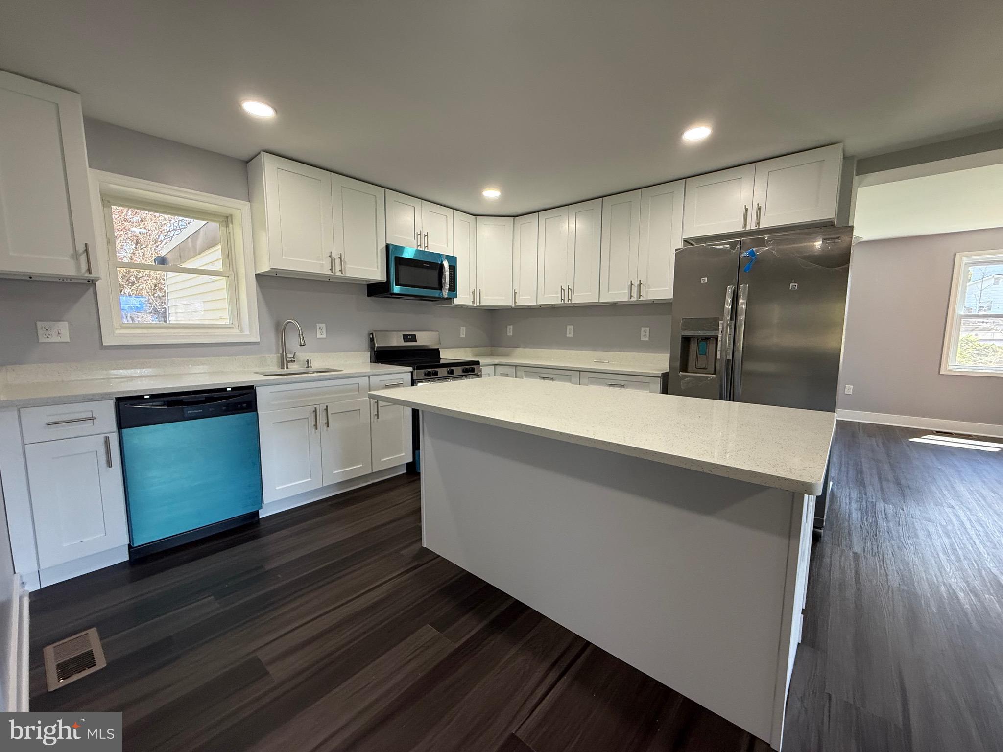 2600 Kingsway Road Fort Washington, MD 20744 - Photo 8 of 37 a kitchen with stainless steel appliances granite countertop a sink a stove a refrigerator cabinets and a wooden floor