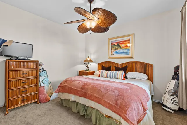 a bedroom with bed and a chandelier