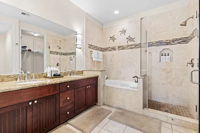 a spacious bathroom with a double vanity sink mirror double shower and a bathtub