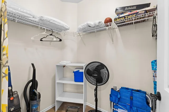 a view of a storage and utility room with racks on the wall