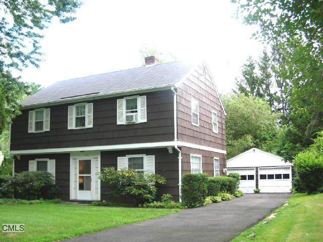 150 Shadow Ridge Road Stamford, CT 06905 - Photo 1 of 1 a front view of a house with a yard and trees