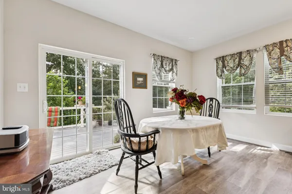 a view of a dining room with furniture and a potted plant