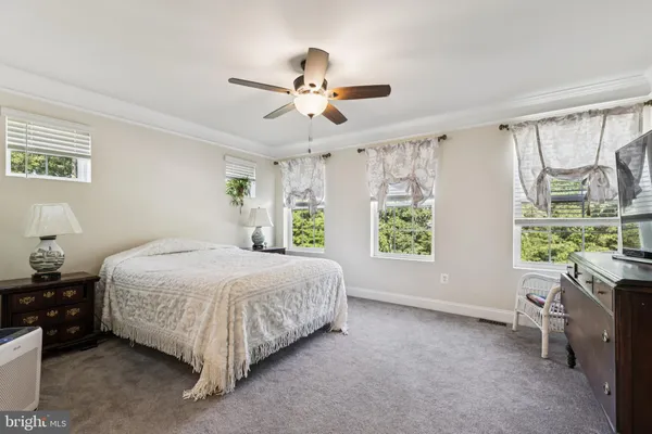 a spacious bedroom with a bed and a window