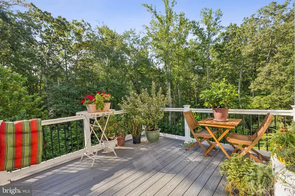 a view of a chairs and table on the wooden deck