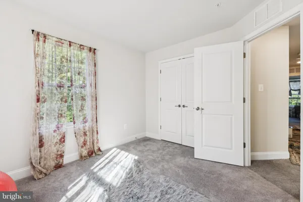 a bathroom with a sink a toilet a mirror and shower curtain