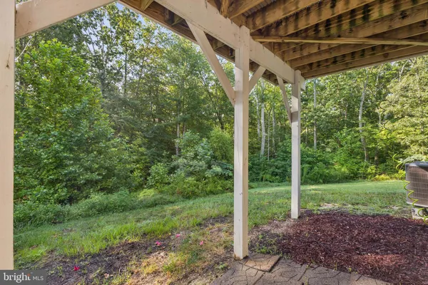 a view of a house with a big yard and a large tree