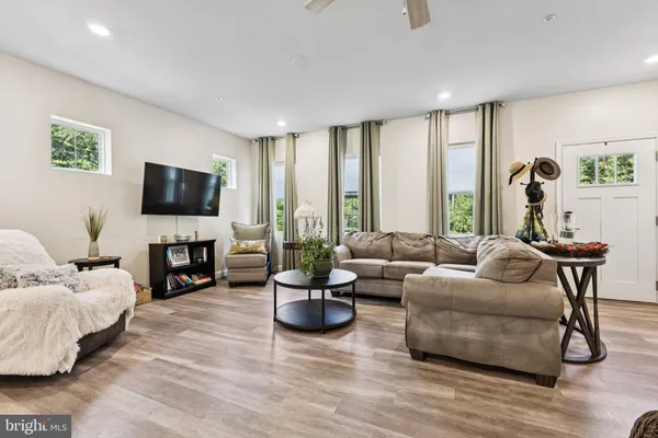 a living room with fireplace furniture and a flat screen tv