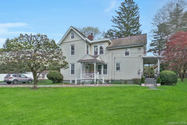 a front view of a house with a garden and plants