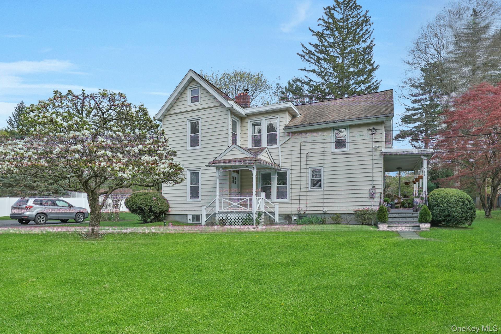 a front view of a house with a garden and plants