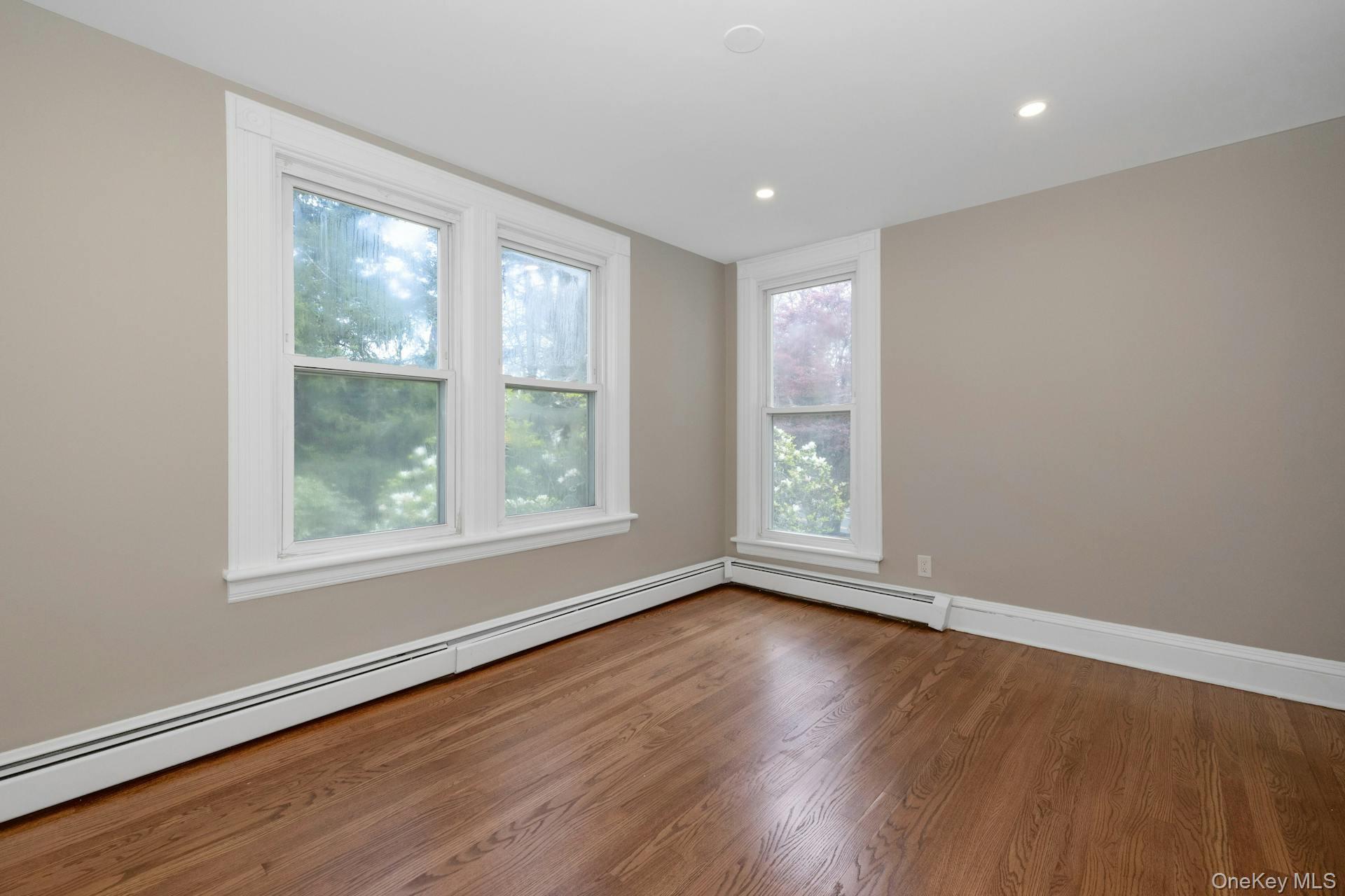 547 King Street, Unit B Chappaqua, NY 10514 - Photo 13 of 19 an empty room with wooden floor and windows
