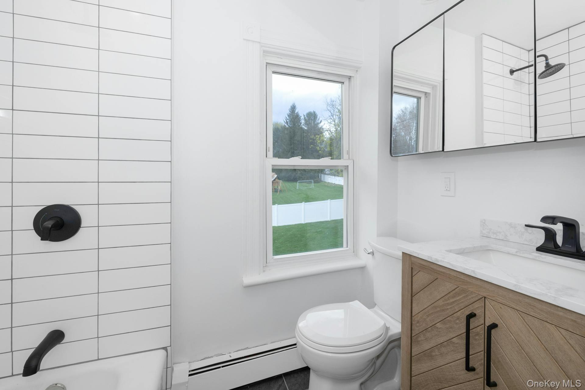 547 King Street, Unit B Chappaqua, NY 10514 - Photo 16 of 19 a bathroom with a sink a toilet and shower