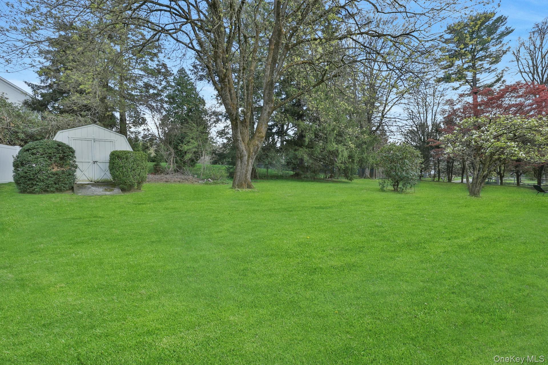 547 King Street, Unit B Chappaqua, NY 10514 - Photo 2 of 19 a view of a grassy field with trees