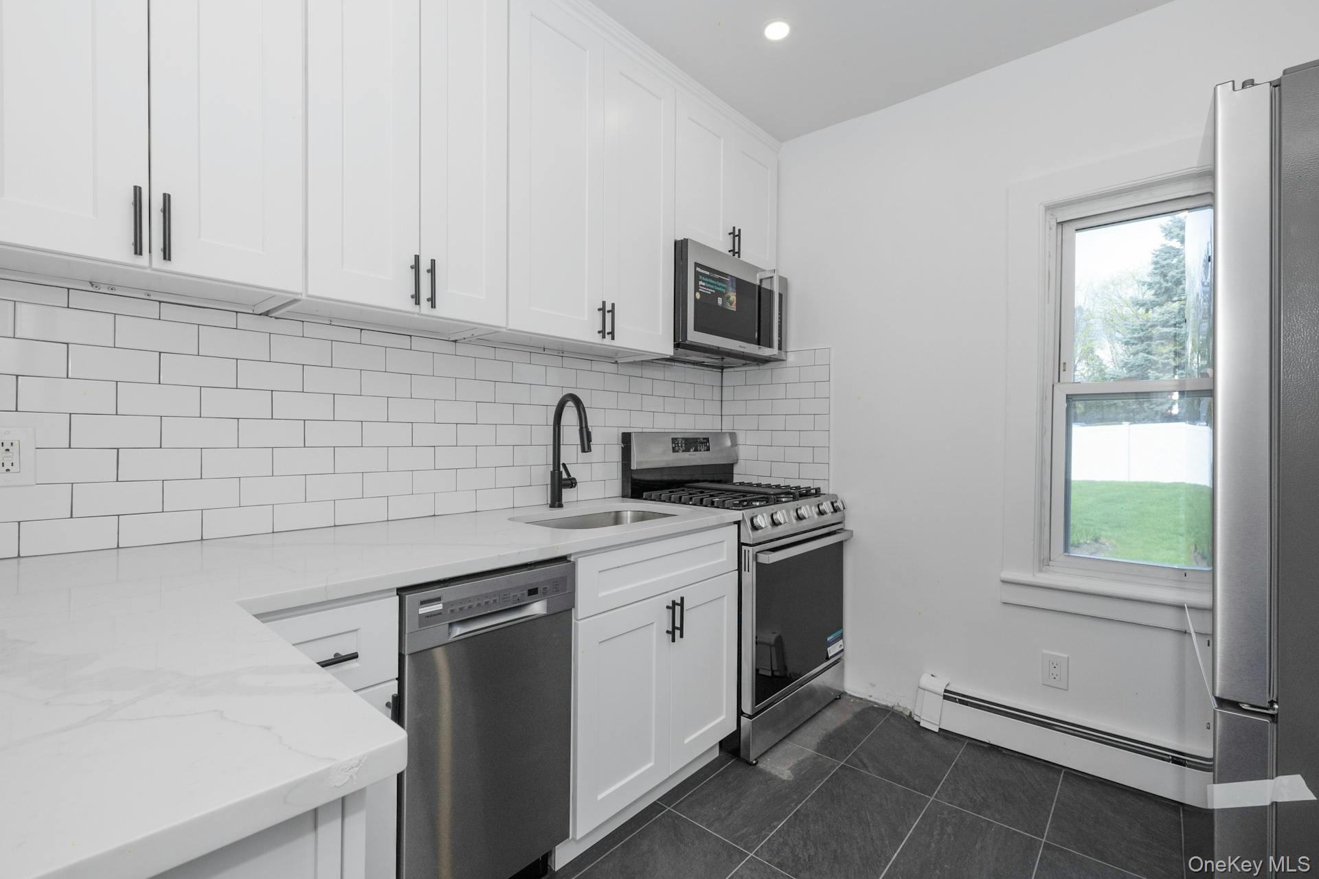 547 King Street, Unit B Chappaqua, NY 10514 - Photo 3 of 19 a kitchen with a sink stove and cabinets