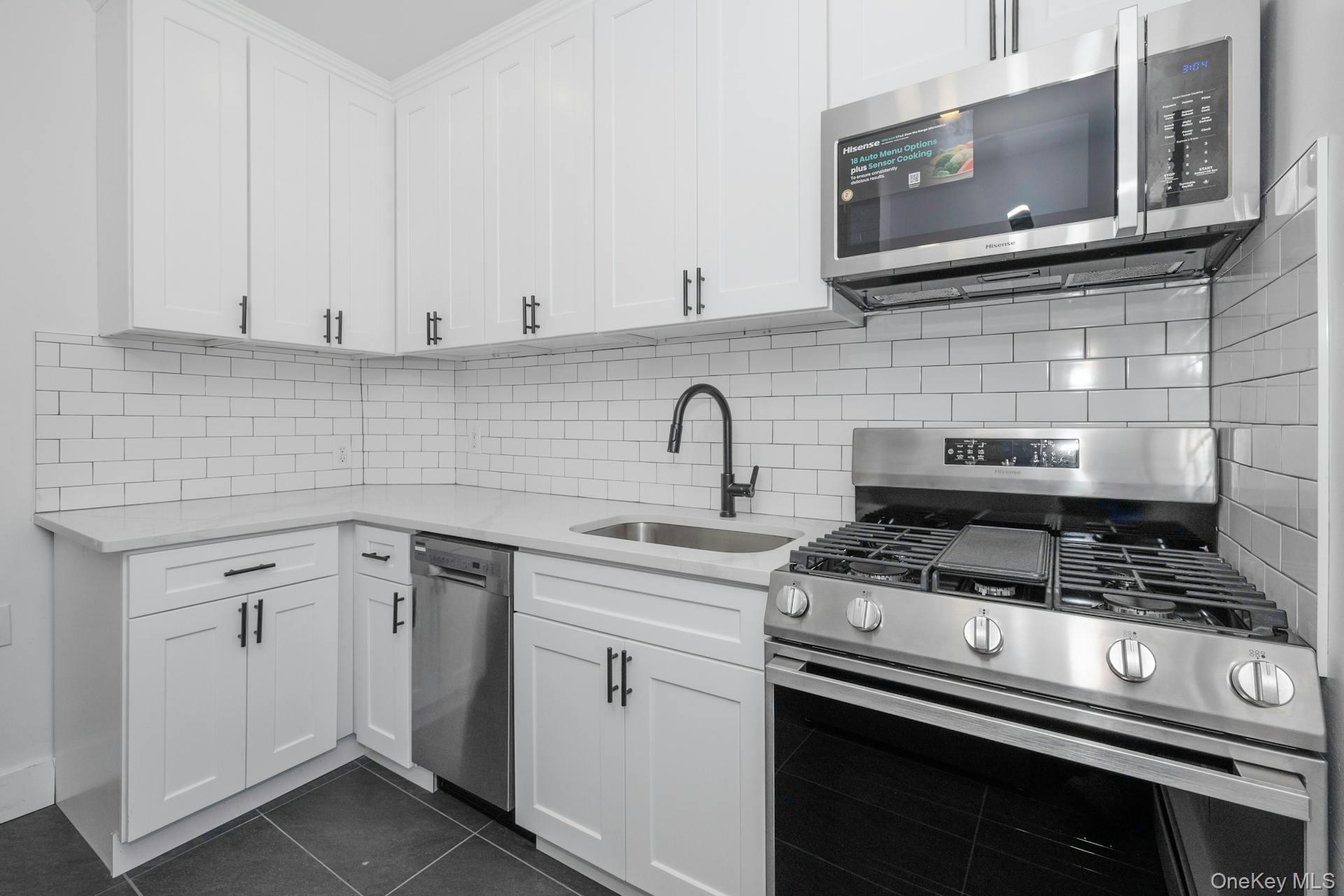 547 King Street, Unit B Chappaqua, NY 10514 - Photo 4 of 19 a kitchen with appliances a sink and cabinets