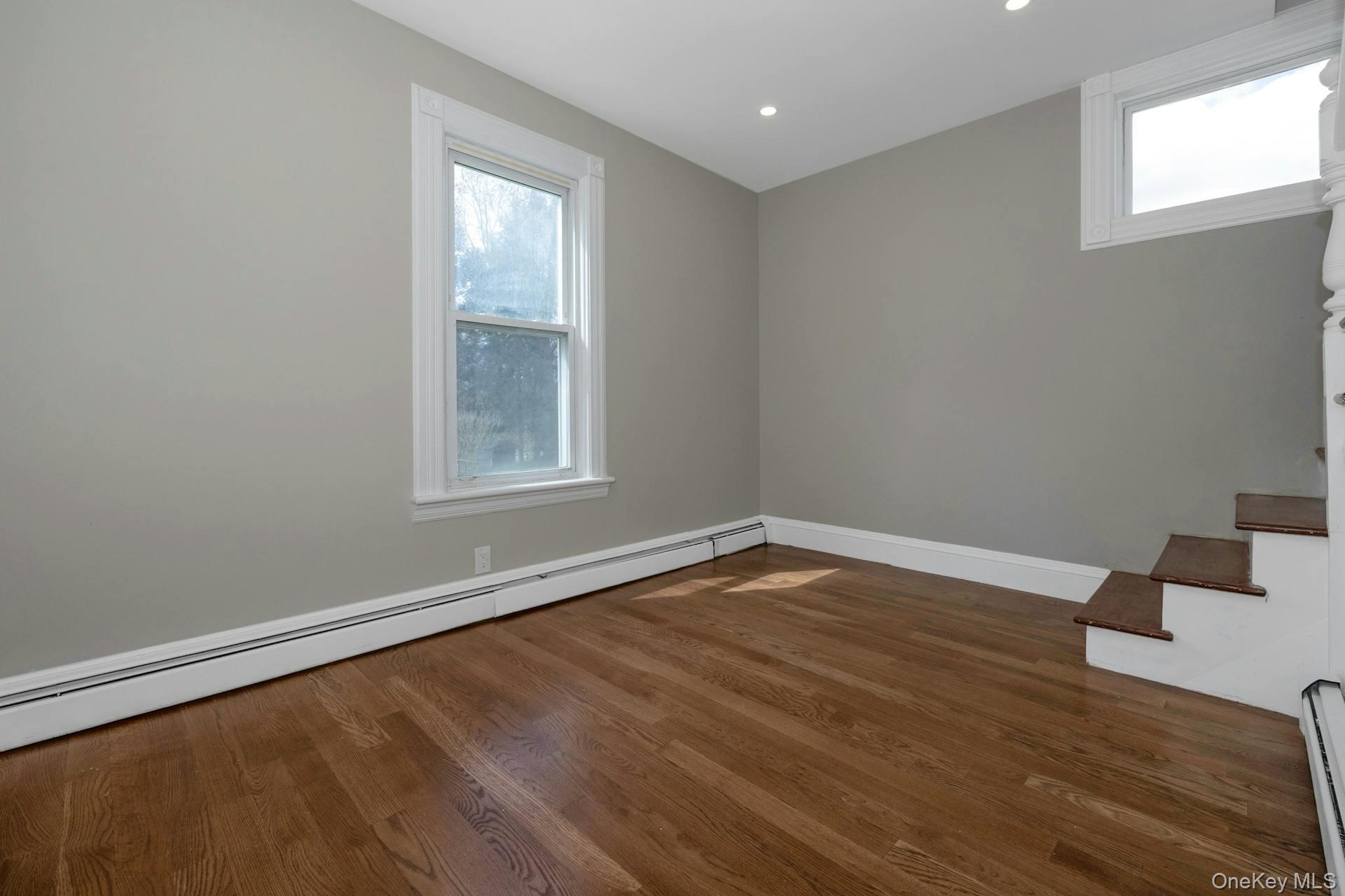 547 King Street, Unit B Chappaqua, NY 10514 - Photo 7 of 19 wooden floor in an empty room with a window