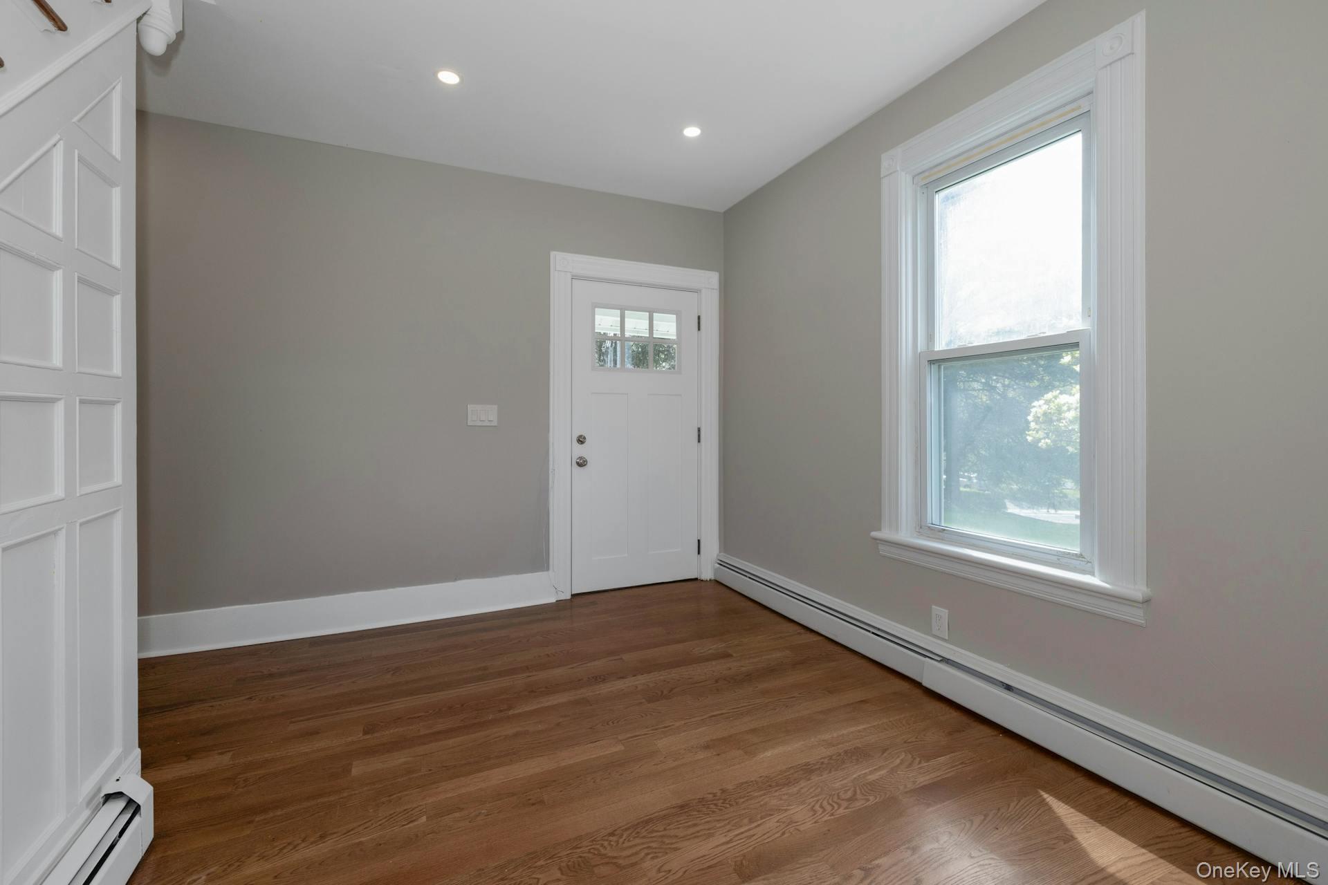 547 King Street, Unit B Chappaqua, NY 10514 - Photo 9 of 19 an empty room with wooden floor and windows