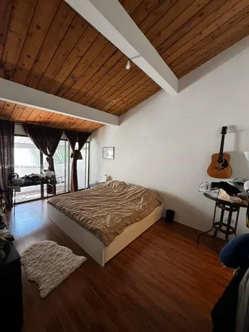 a bed sitting in a room next to a window