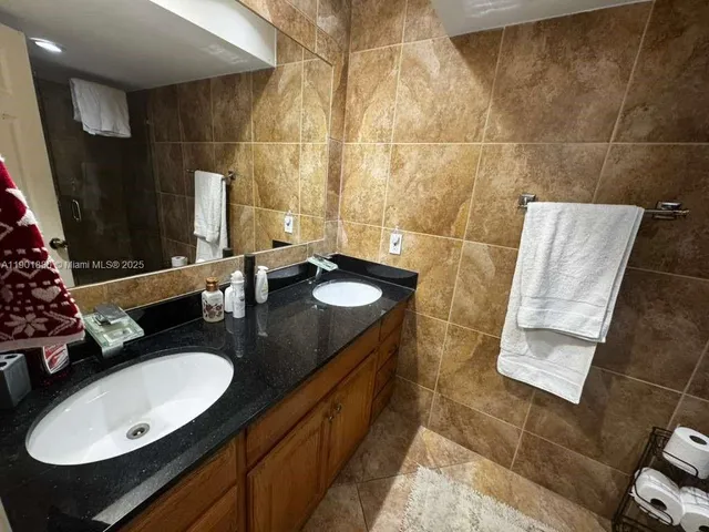 a bathroom with a sink double vanity and a mirror