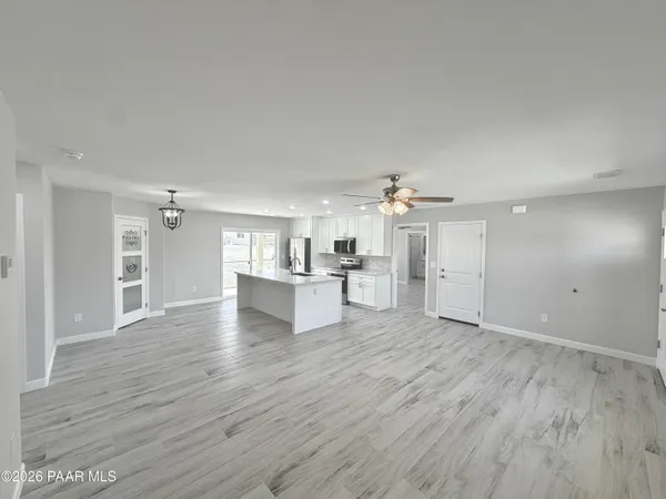 a large kitchen with kitchen island a sink stainless steel appliances and cabinets