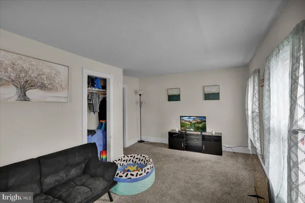 a kitchen with a stove a sink dishwasher and a dining table with wooden cabinet