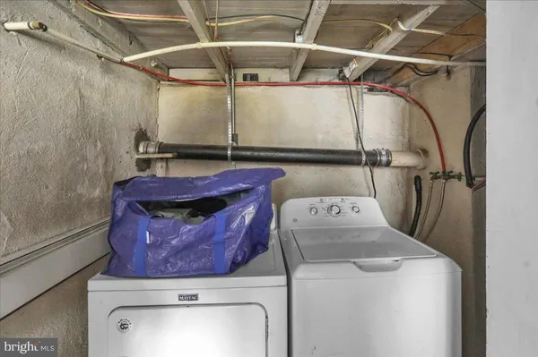 a kitchen with a sink a window and chairs
