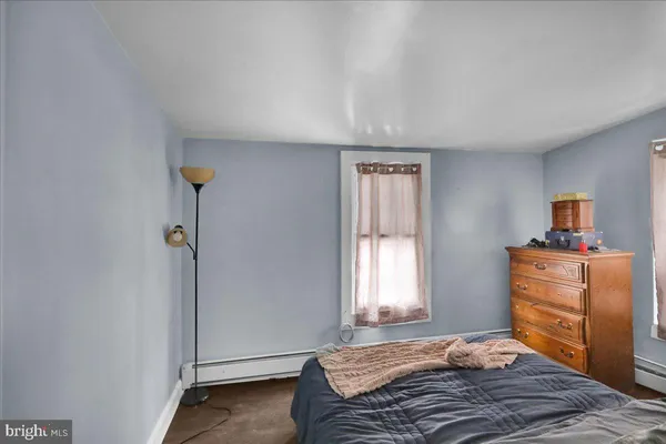 a bed with a small window in front of it