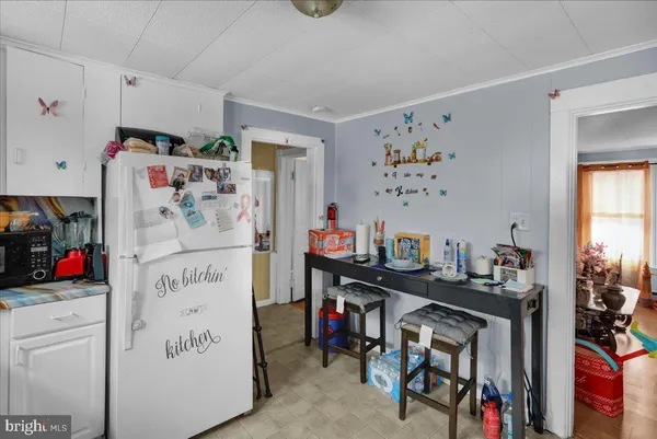 a view of kids room with furniture and window