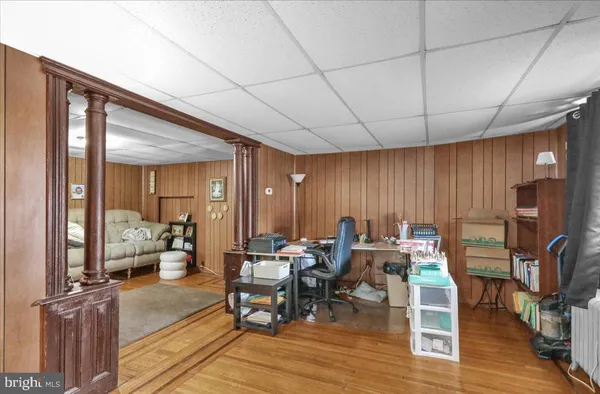 a living room with furniture a flat screen tv and a table
