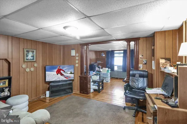 a kitchen with a refrigerator cabinets and wooden floor