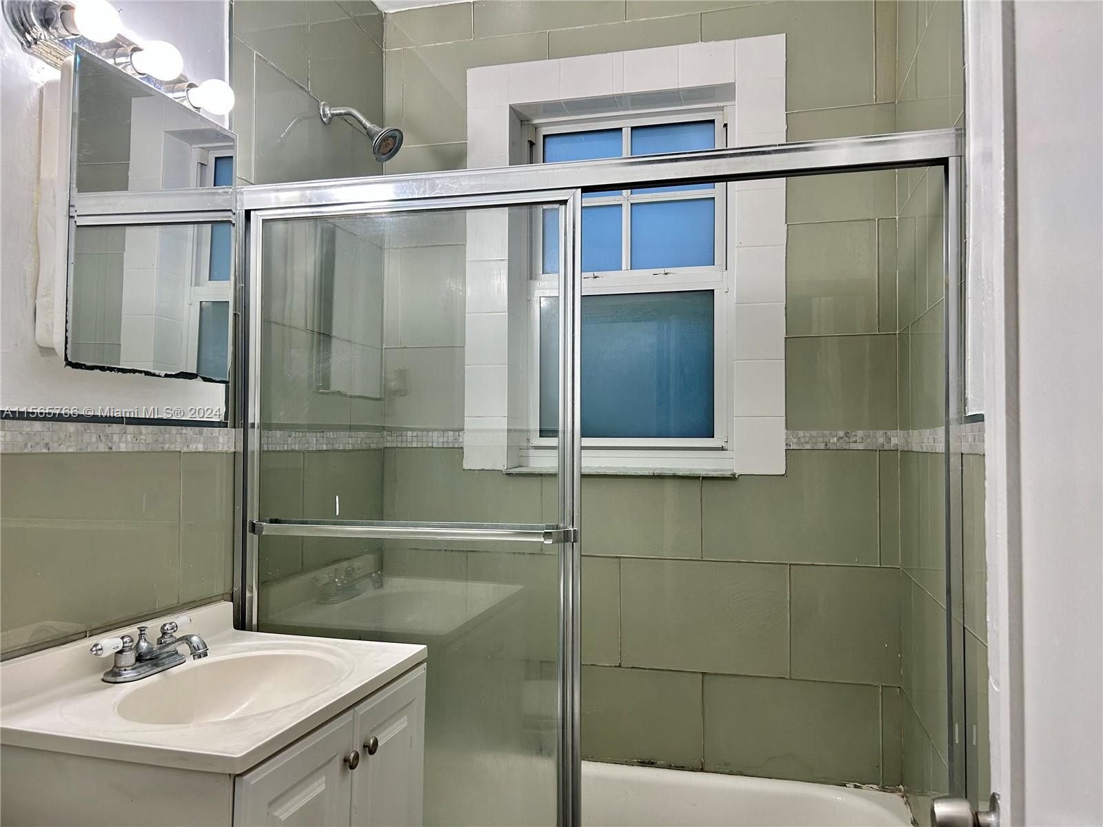 536 14th Street, Unit 107 Miami Beach, FL 33139 - Photo 11 of 13 a bathroom with a sink and mirror