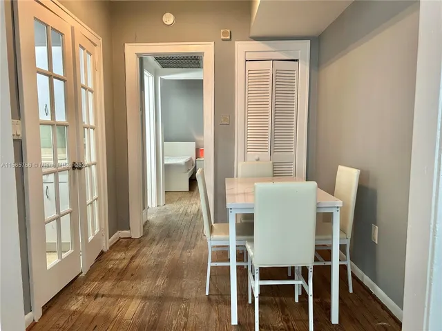 a dining room with furniture and window