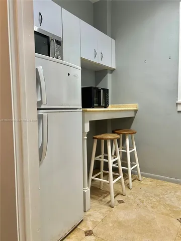 a kitchen with stainless steel appliances a refrigerator and microwave