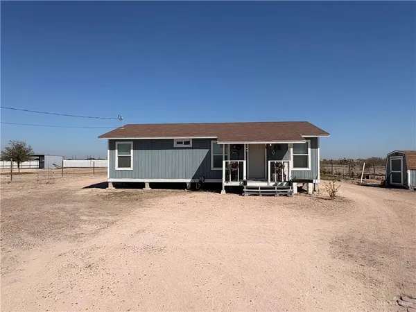 a view of a house with yard and sitting area