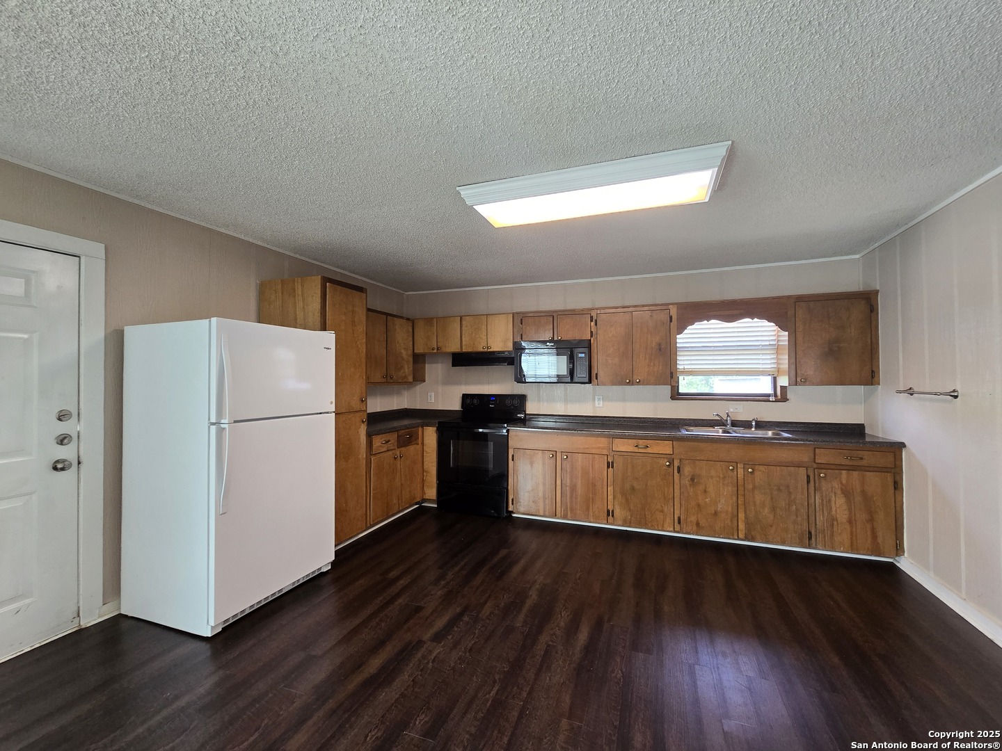 1484 West Klein Road New Braunfels, TX 78130 - Photo 4 of 11 a kitchen with a refrigerator and a stove top oven