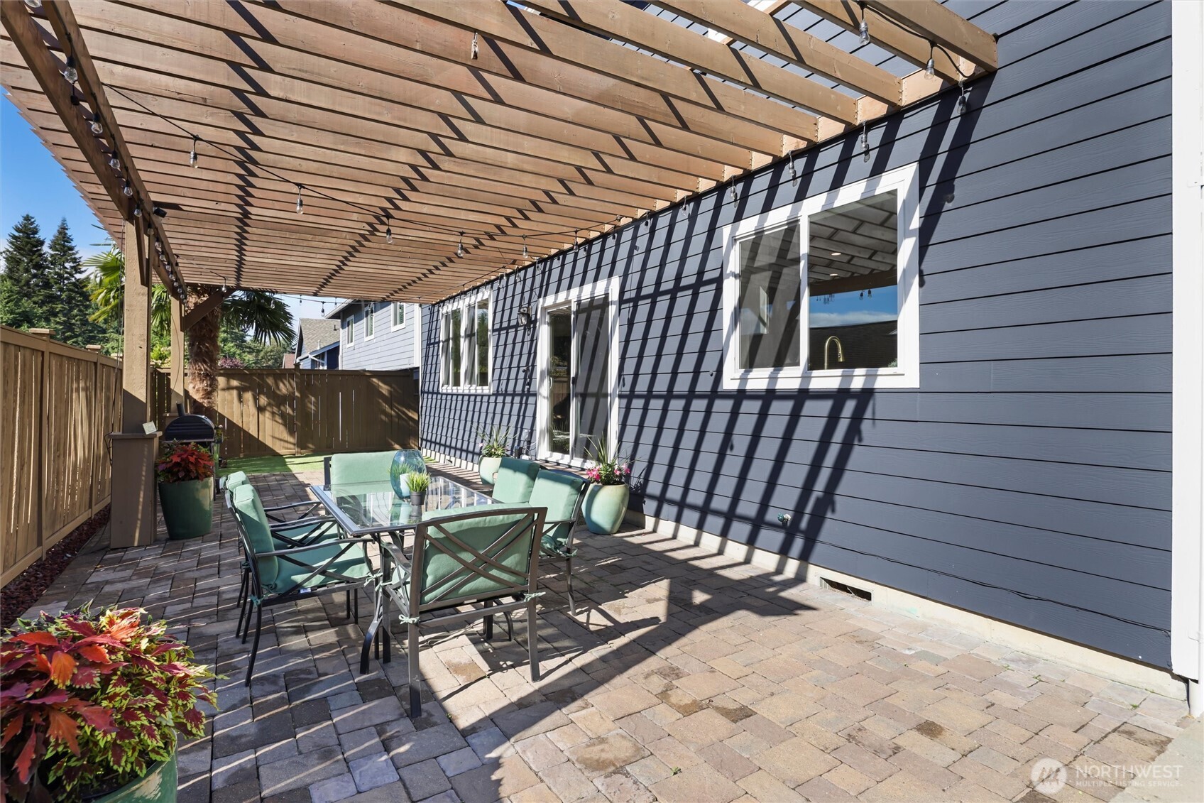 2211 Southwest 103rd Place Seattle, WA 98146 - Photo 2 of 17 a patio with table and chairs and potted plants