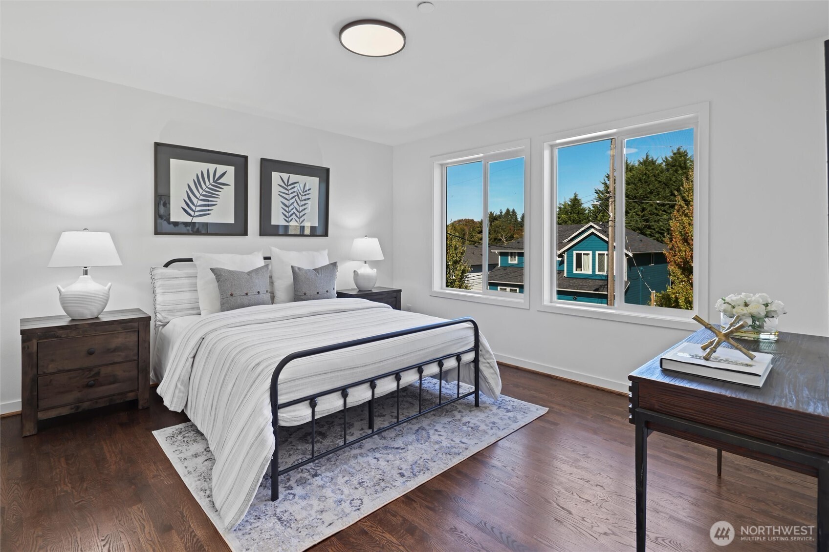 2211 Southwest 103rd Place Seattle, WA 98146 - Photo 10 of 17 a bedroom with a bed a bookshelf and a window