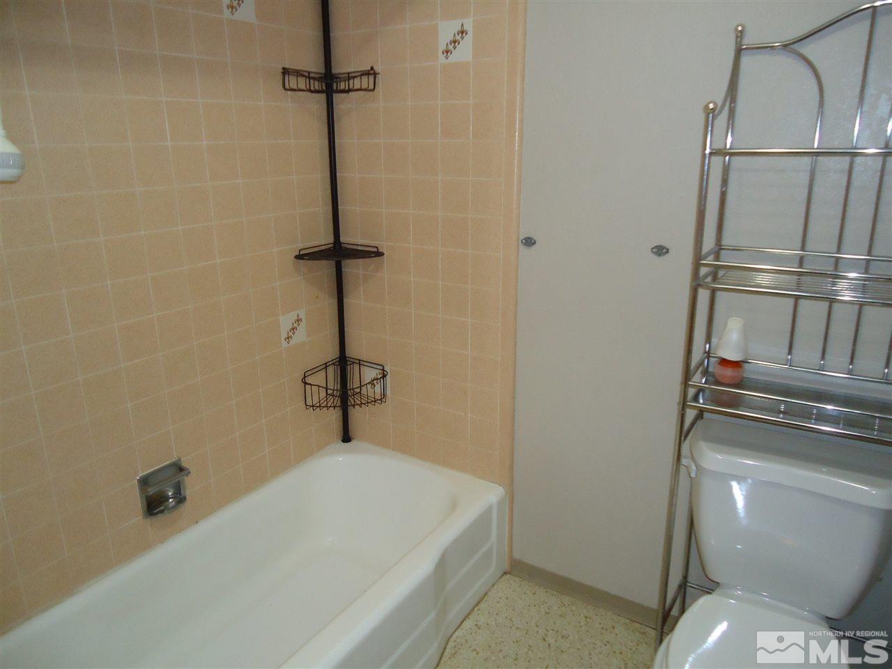 645 Harbin Lane Reno, NV 89509 - Photo 12 of 25 a bathroom with a sink a toilet and shower