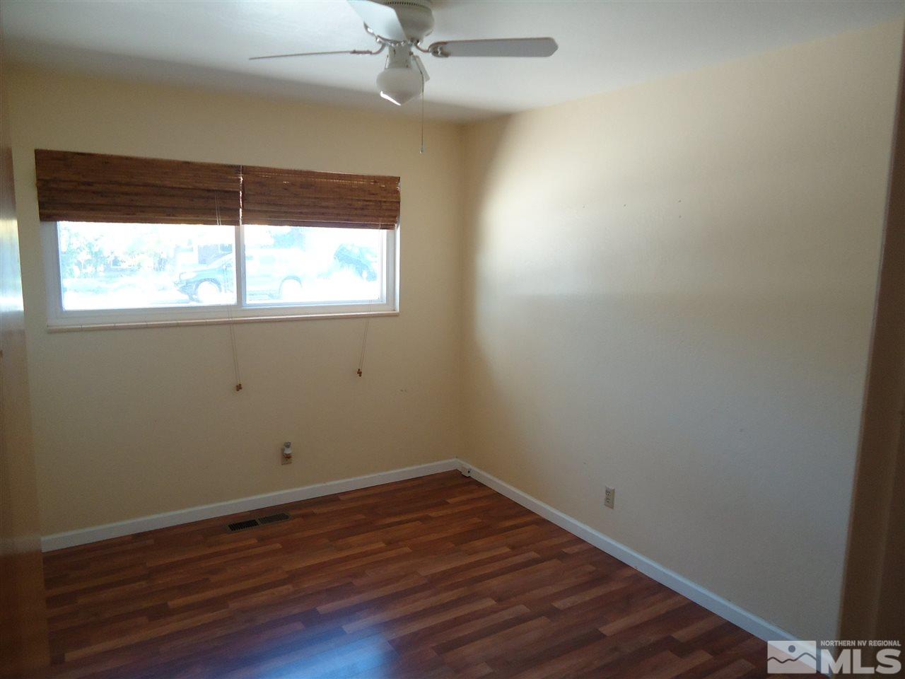 645 Harbin Lane Reno, NV 89509 - Photo 16 of 25 an empty room with wooden floor and windows