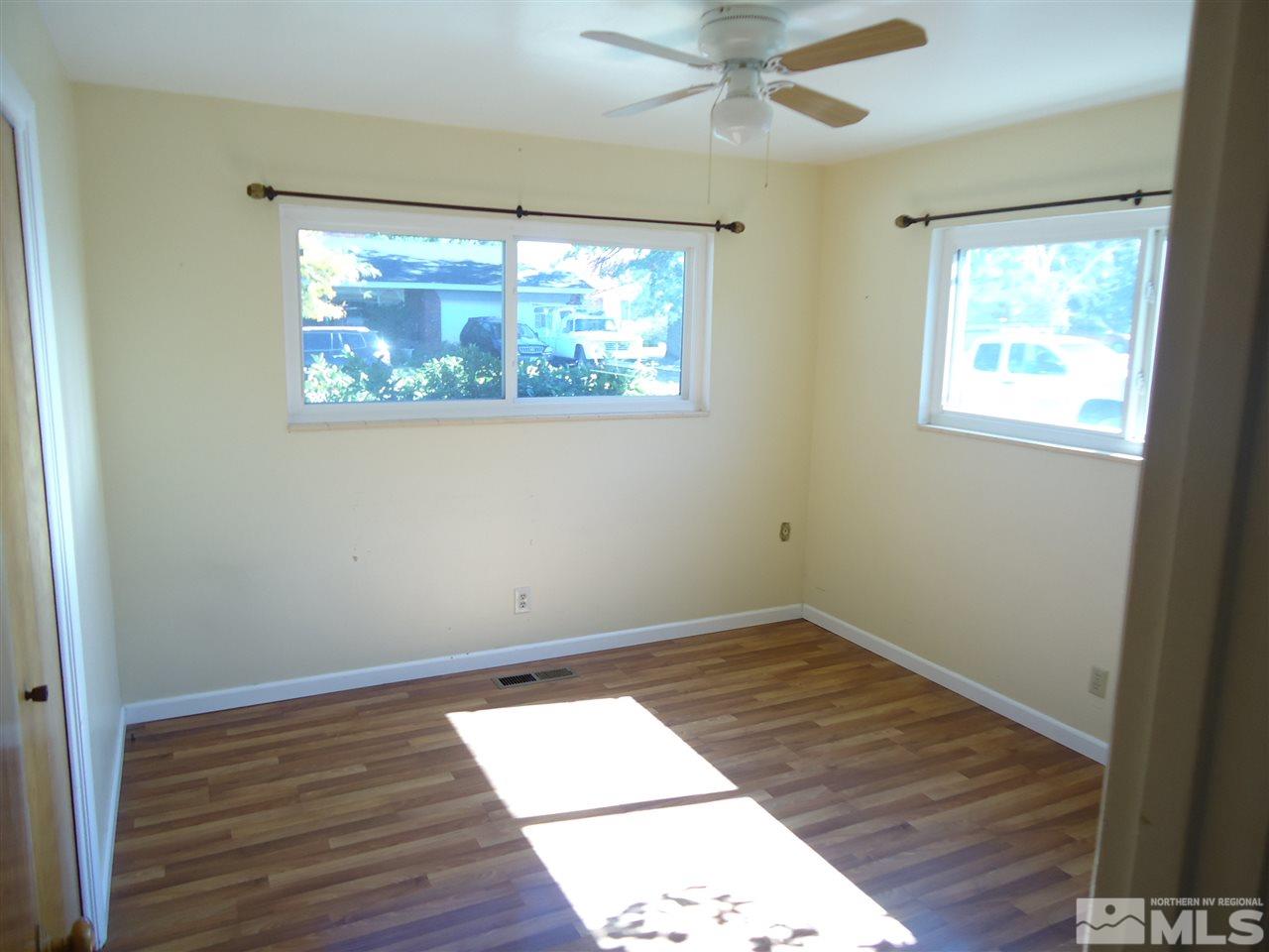 645 Harbin Lane Reno, NV 89509 - Photo 17 of 25 an empty room with wooden floor and windows