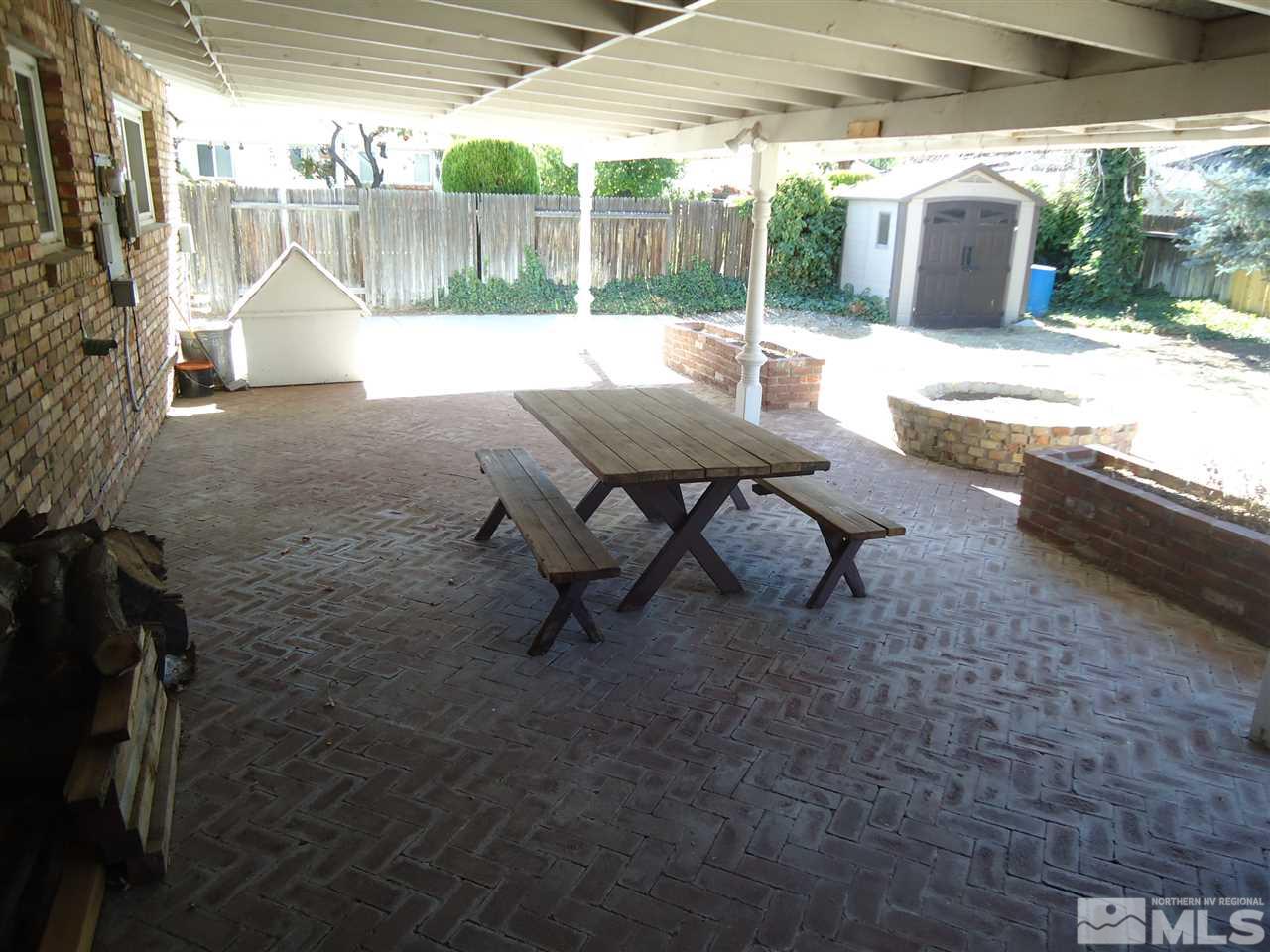 645 Harbin Lane Reno, NV 89509 - Photo 23 of 25 a backyard of a house with table and chairs