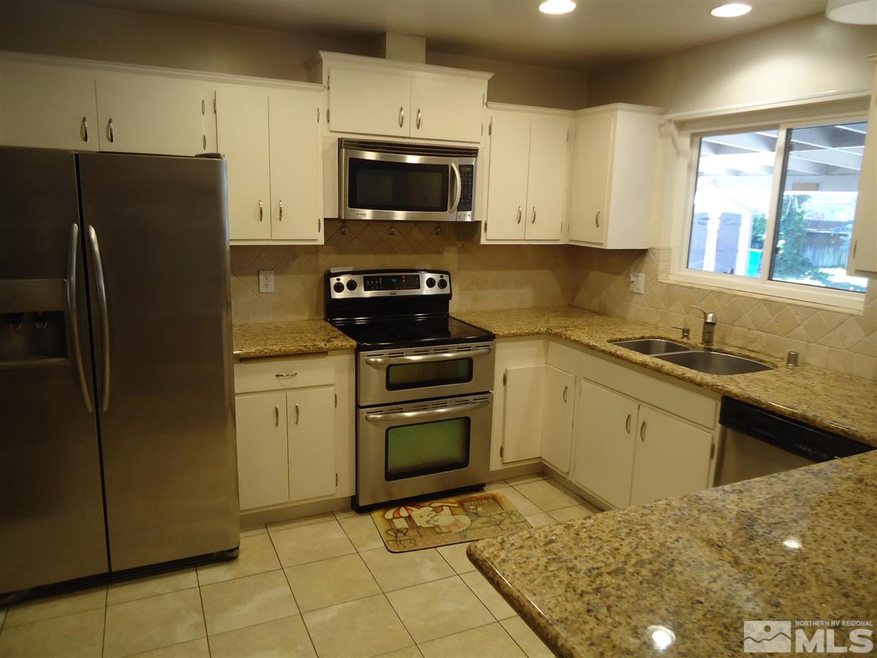 645 Harbin Lane Reno, NV 89509 - Photo 3 of 25 a kitchen with a sink stove and refrigerator
