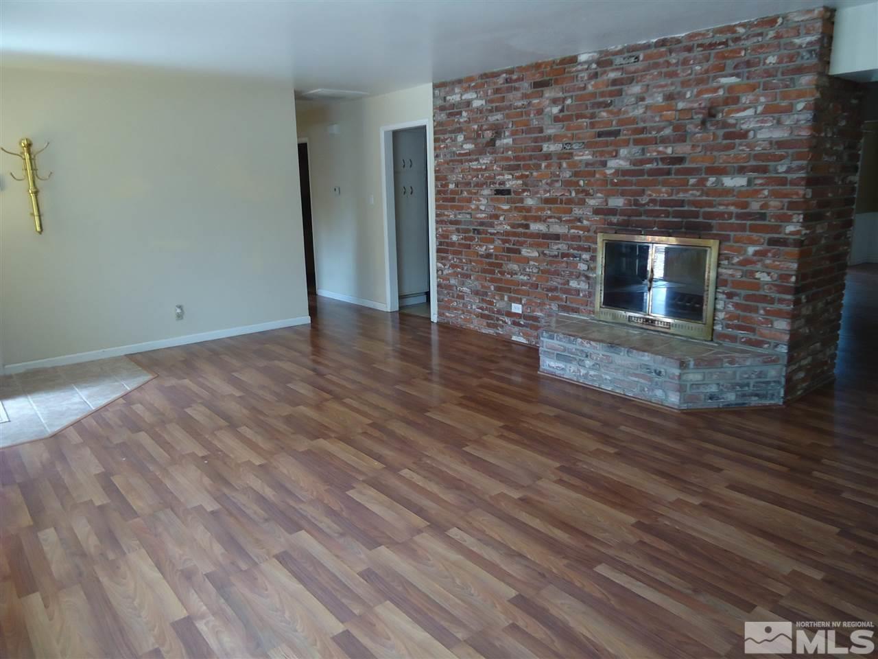 645 Harbin Lane Reno, NV 89509 - Photo 5 of 25 a view of an empty room with wooden floor and a fireplace