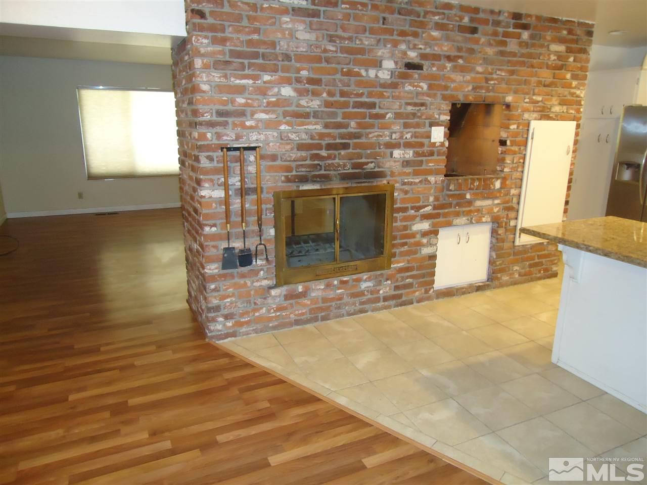 645 Harbin Lane Reno, NV 89509 - Photo 6 of 25 a view of a livingroom with wooden floor and a fireplace