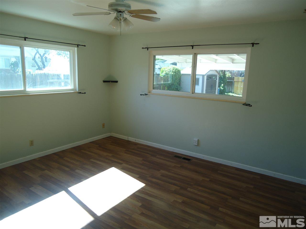645 Harbin Lane Reno, NV 89509 - Photo 9 of 25 a view of an empty room with wooden floor and a window